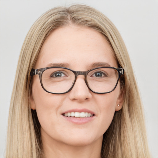 Joyful white young-adult female with long  brown hair and blue eyes