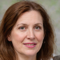 Joyful white adult female with medium  brown hair and grey eyes