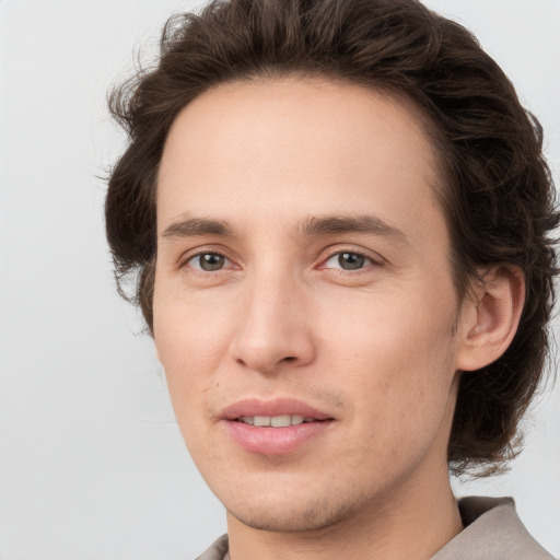 Joyful white young-adult male with medium  brown hair and brown eyes