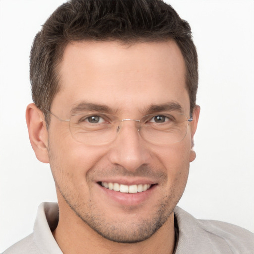 Joyful white young-adult male with short  brown hair and brown eyes