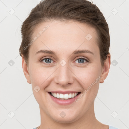 Joyful white young-adult female with short  brown hair and grey eyes