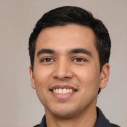 Joyful white young-adult male with short  black hair and brown eyes