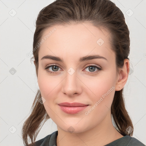 Joyful white young-adult female with medium  brown hair and grey eyes