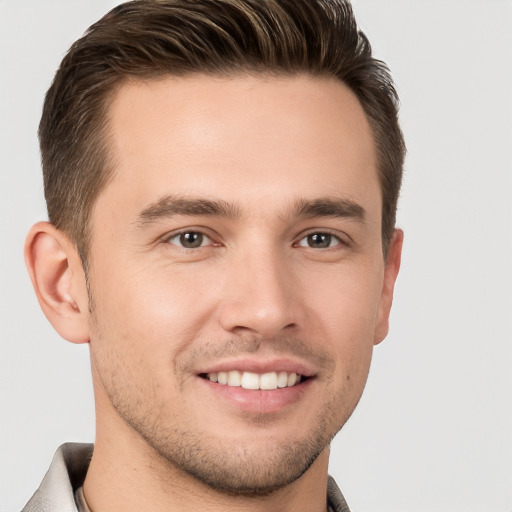 Joyful white young-adult male with short  brown hair and brown eyes