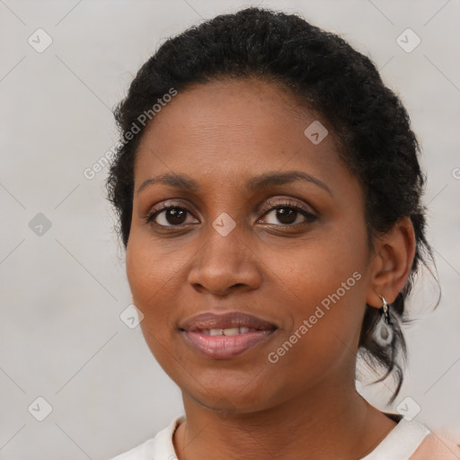 Joyful black young-adult female with short  brown hair and brown eyes