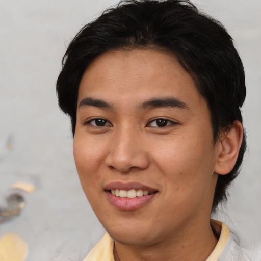 Joyful asian young-adult female with short  brown hair and brown eyes