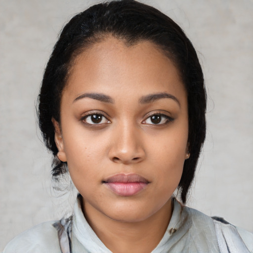 Joyful latino young-adult female with medium  black hair and brown eyes