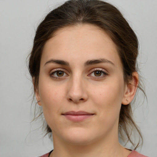 Joyful white young-adult female with medium  brown hair and green eyes