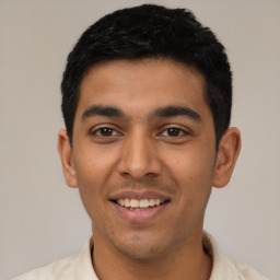 Joyful latino young-adult male with short  black hair and brown eyes