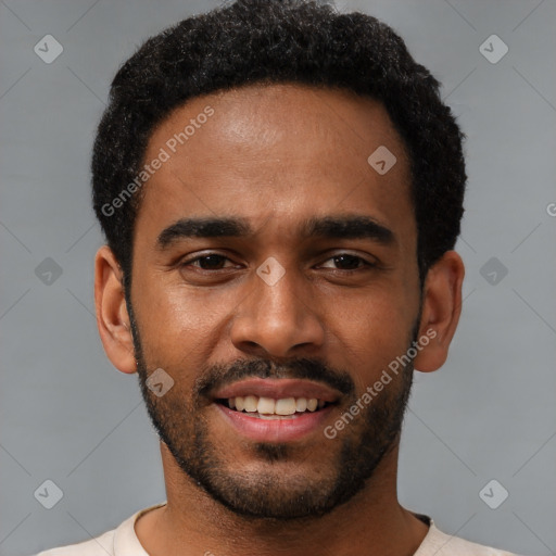 Joyful black young-adult male with short  black hair and brown eyes