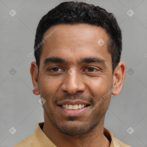 Joyful latino young-adult male with short  black hair and brown eyes