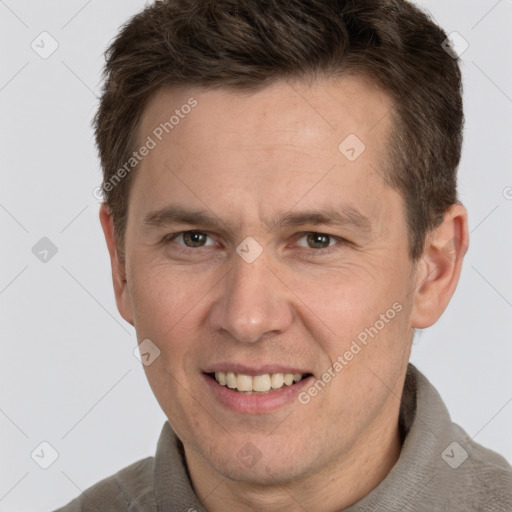 Joyful white adult male with short  brown hair and grey eyes