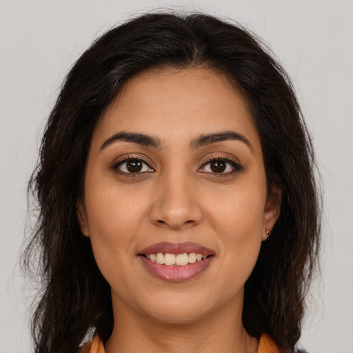 Joyful white young-adult female with long  brown hair and brown eyes
