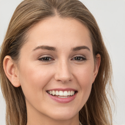 Joyful white young-adult female with long  brown hair and grey eyes