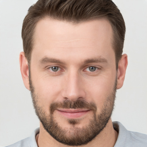 Joyful white young-adult male with short  brown hair and brown eyes