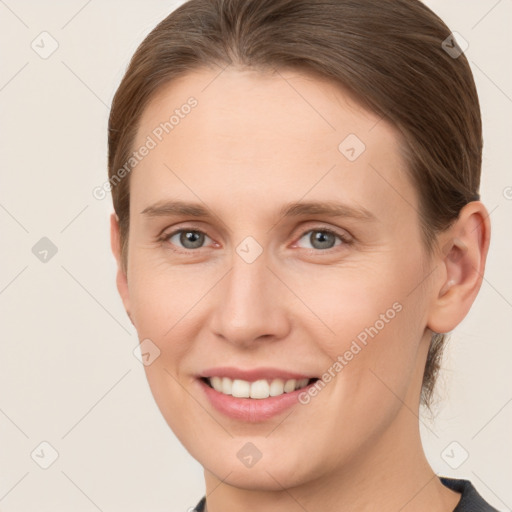 Joyful white young-adult female with medium  brown hair and grey eyes