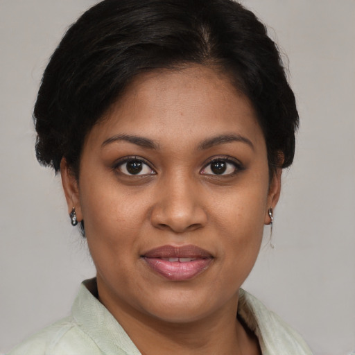 Joyful black young-adult female with medium  brown hair and brown eyes