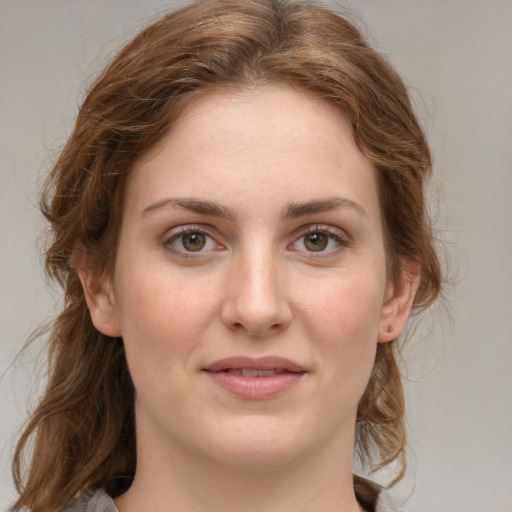 Joyful white young-adult female with medium  brown hair and green eyes