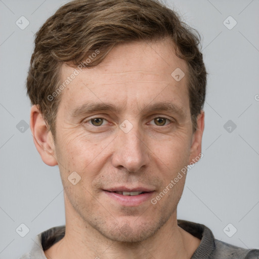 Joyful white adult male with short  brown hair and grey eyes