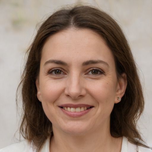 Joyful white adult female with medium  brown hair and brown eyes