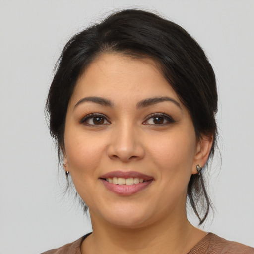 Joyful latino young-adult female with medium  brown hair and brown eyes