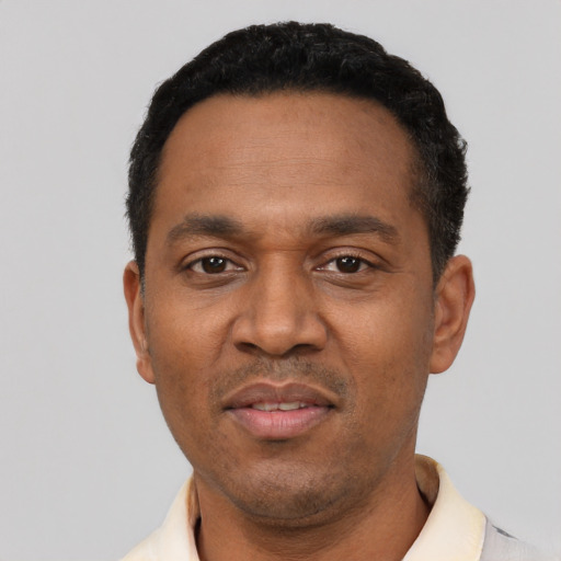 Joyful latino adult male with short  black hair and brown eyes