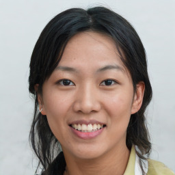 Joyful asian young-adult female with medium  black hair and brown eyes