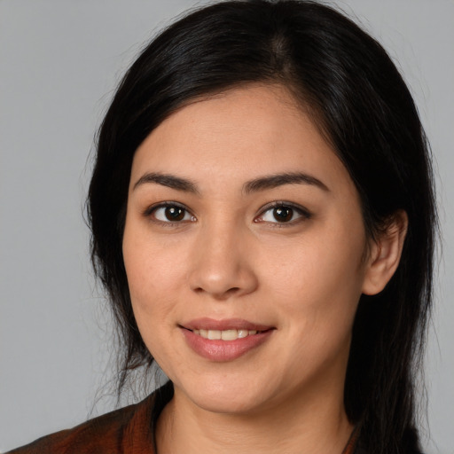 Joyful white young-adult female with long  black hair and brown eyes