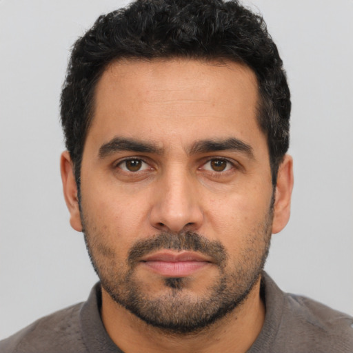 Neutral latino young-adult male with short  black hair and brown eyes