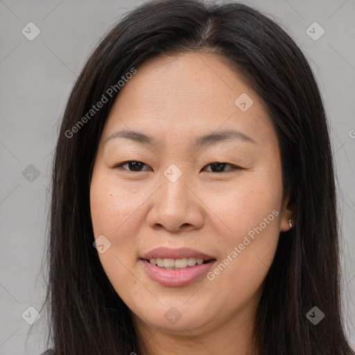 Joyful asian young-adult female with long  brown hair and brown eyes