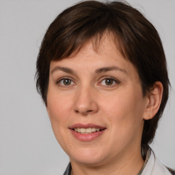 Joyful white adult female with medium  brown hair and brown eyes