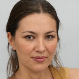 Joyful white adult female with medium  brown hair and brown eyes