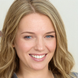 Joyful white young-adult female with long  brown hair and blue eyes