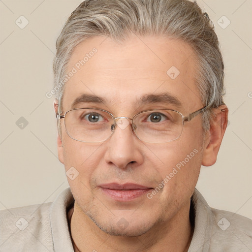 Joyful white middle-aged male with short  brown hair and brown eyes