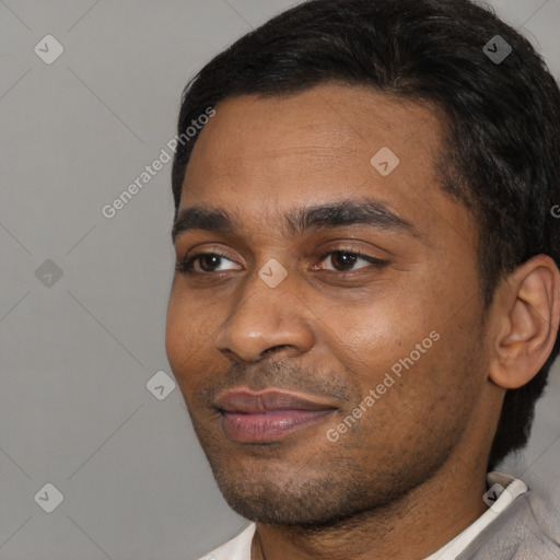 Joyful black young-adult male with short  black hair and brown eyes