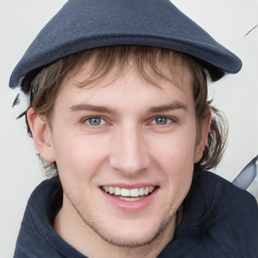 Joyful white young-adult male with medium  brown hair and blue eyes