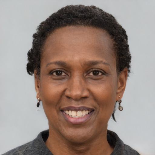 Joyful black adult female with short  brown hair and brown eyes