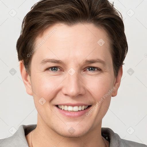 Joyful white young-adult female with short  brown hair and grey eyes