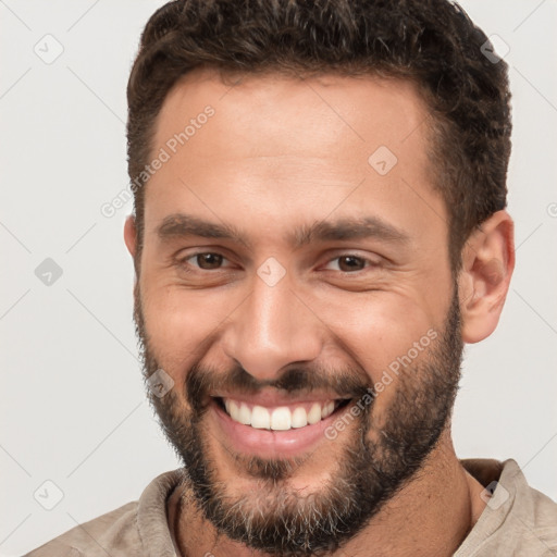 Joyful white young-adult male with short  brown hair and brown eyes