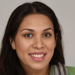 Joyful latino young-adult female with long  brown hair and brown eyes