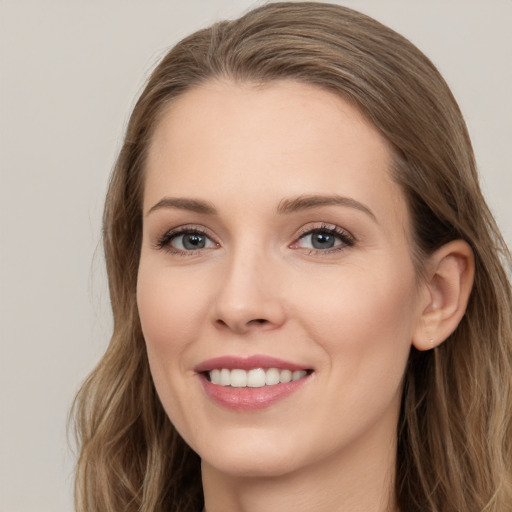 Joyful white young-adult female with long  brown hair and grey eyes