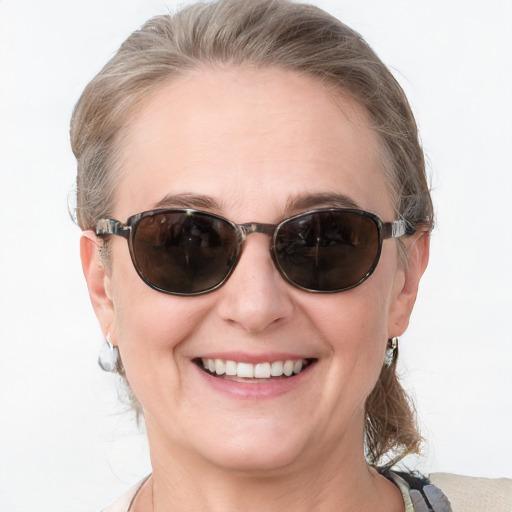 Joyful white adult female with medium  brown hair and blue eyes