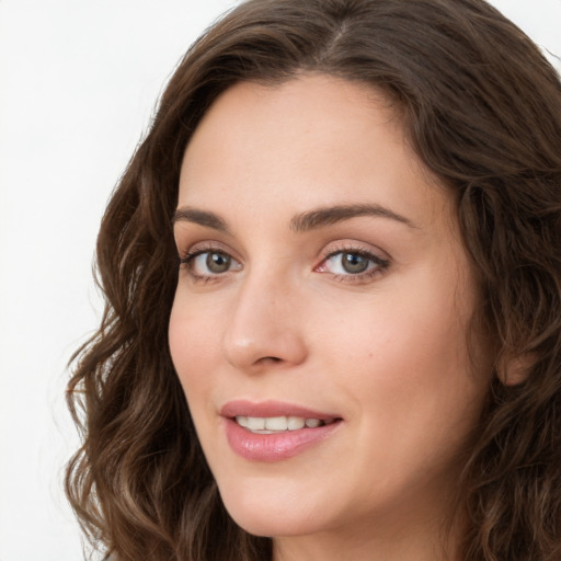 Joyful white young-adult female with long  brown hair and green eyes