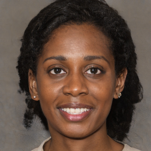 Joyful black young-adult female with medium  black hair and brown eyes