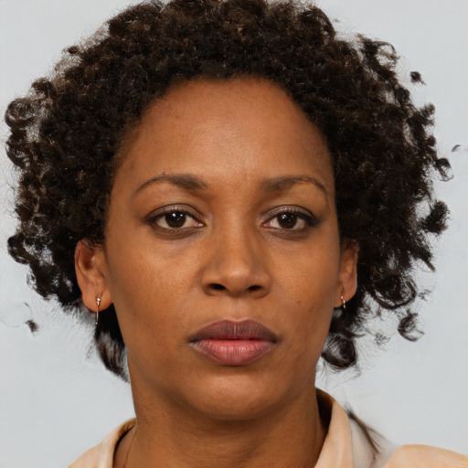 Neutral black adult female with medium  brown hair and brown eyes