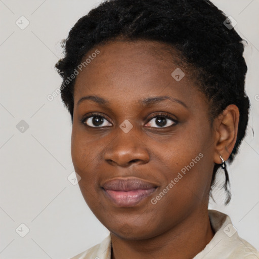 Joyful black young-adult female with short  black hair and brown eyes