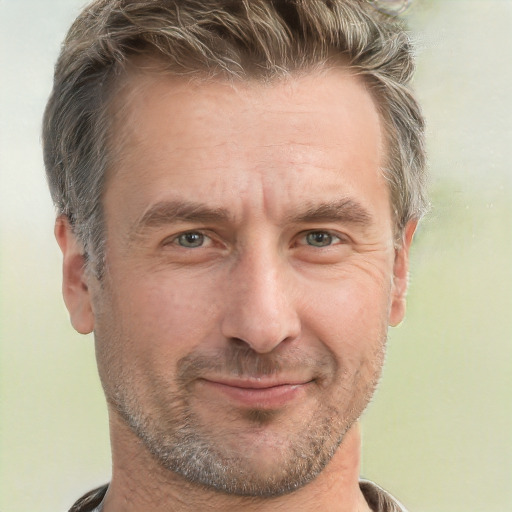 Joyful white adult male with short  brown hair and grey eyes