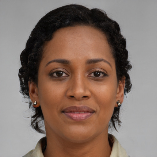 Joyful black young-adult female with medium  brown hair and brown eyes