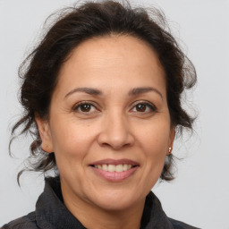 Joyful white adult female with medium  brown hair and brown eyes