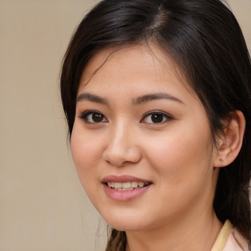 Joyful white young-adult female with medium  brown hair and brown eyes